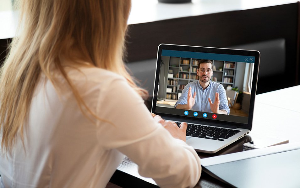 A woman attending a virtual meeting on a laptop in a modern workspace | MSC Cruises A woman attending a virtual meeting on a laptop in a modern workspace | MSC Cruises