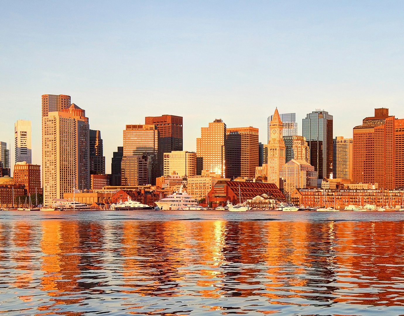 Boston skyline at sunset with waterfront reflections | MSC Cruises
