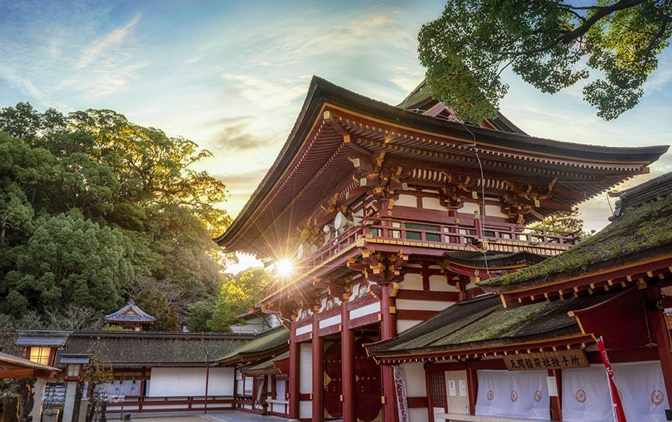 Traditional Japanese shrine surrounded by lush greenery at sunset | MSC Cruises Traditional Japanese shrine surrounded by lush greenery at sunset | MSC Cruises