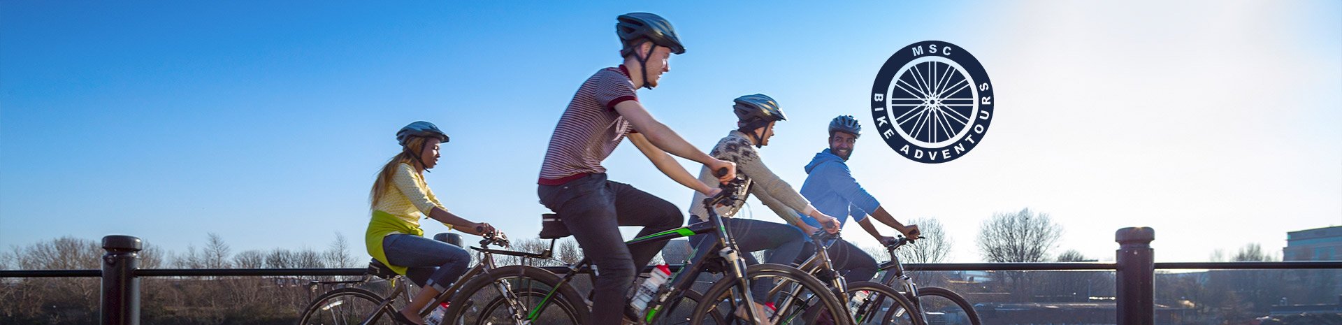 Cyclists riding along a scenic path with MSC Bike Adventures logo | MSC Cruises Cyclists riding along a scenic path with MSC Bike Adventures logo | MSC Cruises