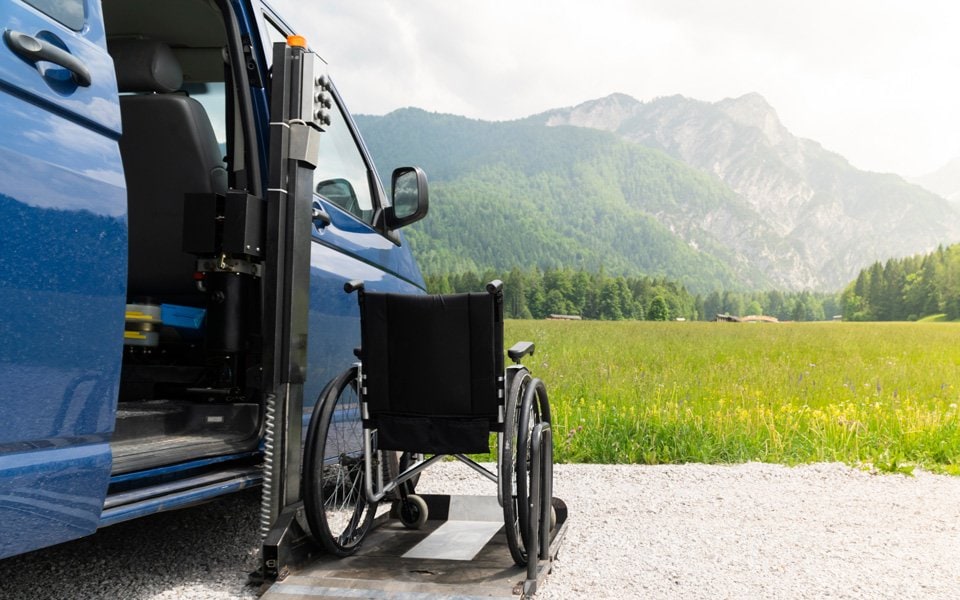 Accessible van with wheelchair lift in a scenic mountain setting | MSC Cruises Accessible van with wheelchair lift in a scenic mountain setting | MSC Cruises