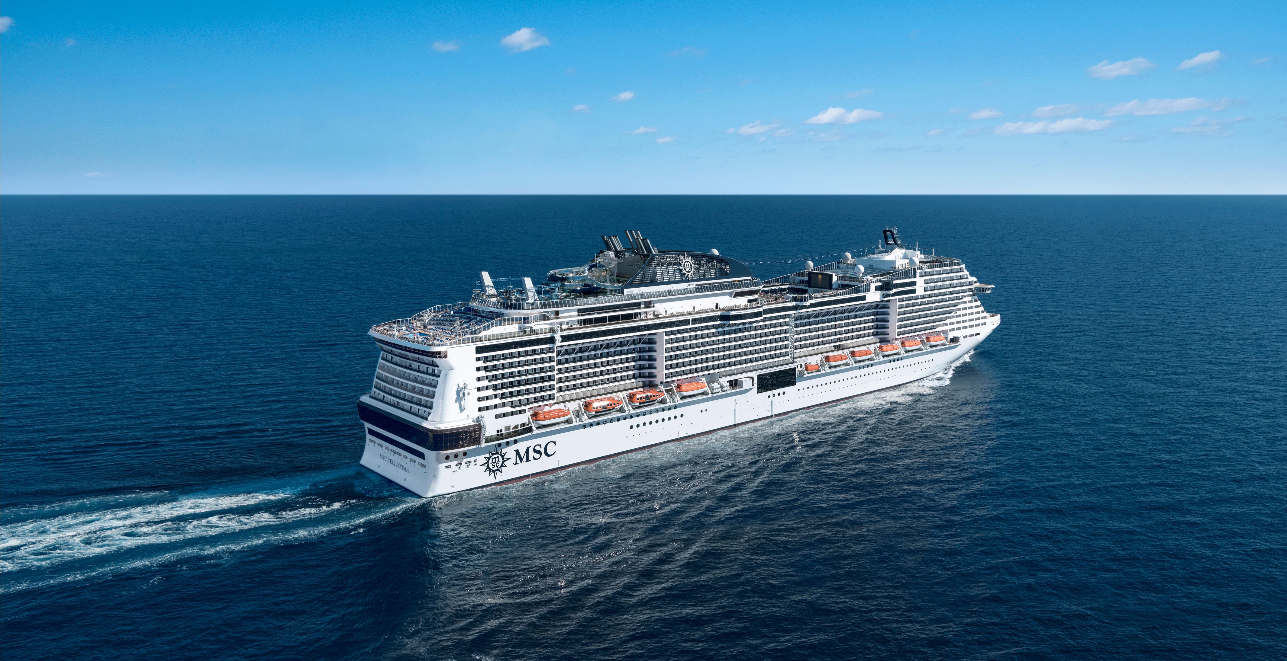 An MSC cruise ship sailing on calm blue waters under a clear sky | MSC Cruises An MSC cruise ship sailing on calm blue waters under a clear sky | MSC Cruises