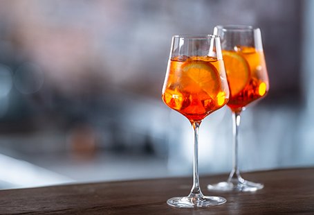 Two glasses of Aperol Spritz on a wooden bar | MSC Cruises