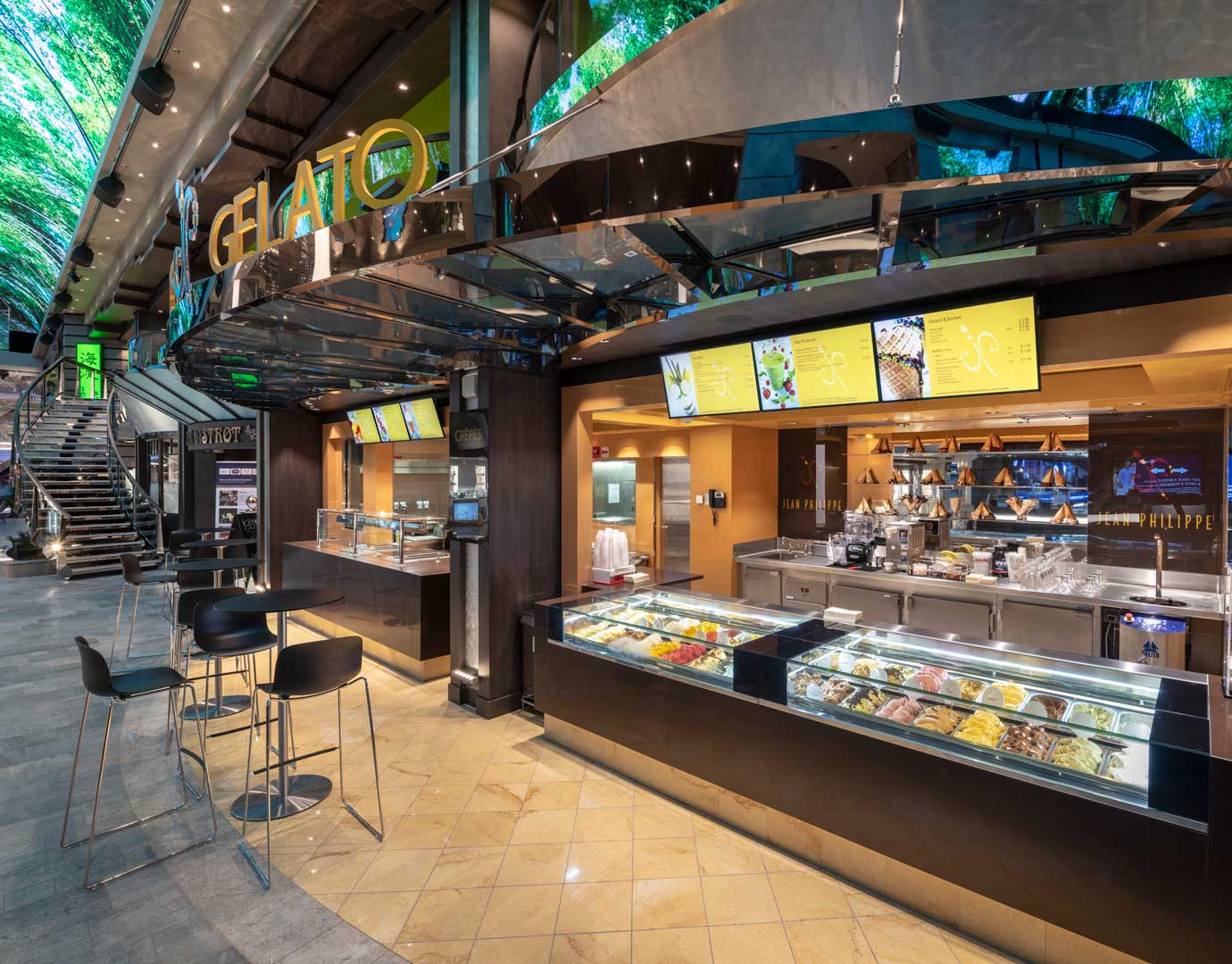 Gelato counter with colorful ice cream displays and seating on an MSC Cruises ship | MSC Cruises Gelato counter with colorful ice cream displays and seating on an MSC Cruises ship | MSC Cruises