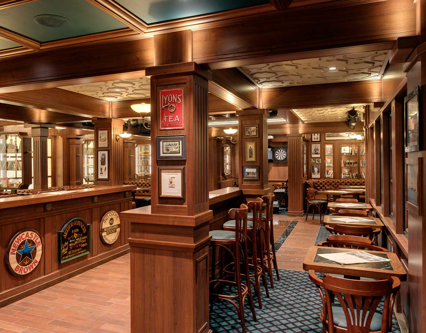 Cozy onboard pub with wooden decor, dartboard, and seating area | MSC Cruises Cozy onboard pub with wooden decor, dartboard, and seating area | MSC Cruises