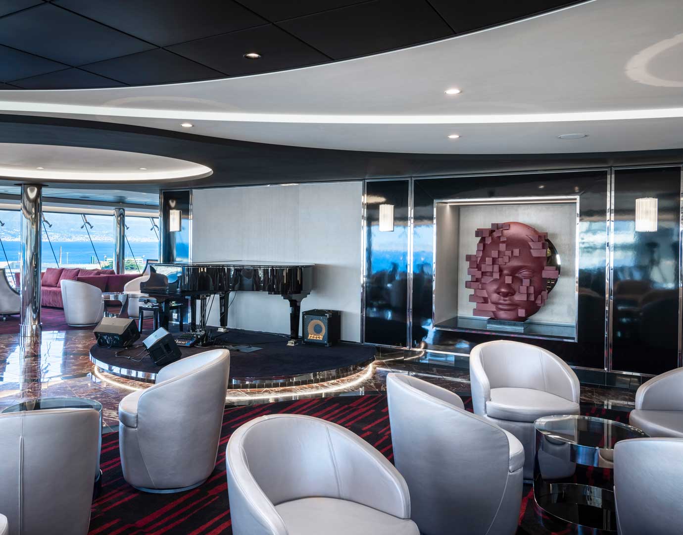 Elegant cruise ship lounge with modern decor, grand piano, and ocean views | MSC Cruises Elegant cruise ship lounge with modern decor, grand piano, and ocean views | MSC Cruises
