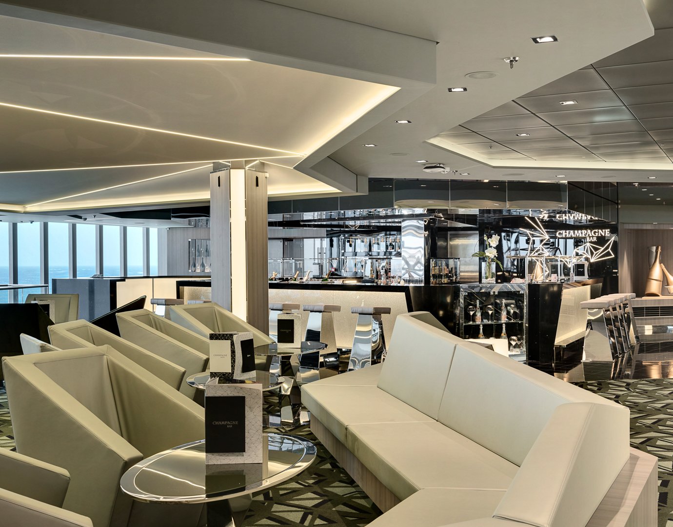 Luxurious champagne bar with modern seating and ocean views onboard | MSC Cruises Luxurious champagne bar with modern seating and ocean views onboard | MSC Cruises