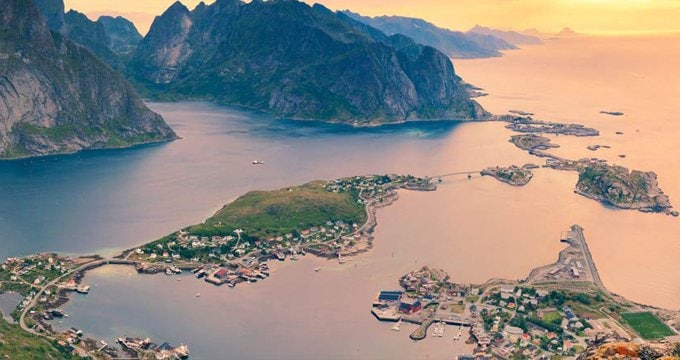 Scenic view of Norwegian fjords with small coastal villages and rugged mountains | MSC Cruises Scenic view of Norwegian fjords with small coastal villages and rugged mountains | MSC Cruises